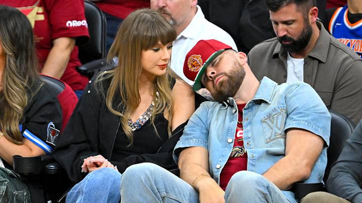 Hours after Kansas City beat Miami, Travis showed up late at the VMAs, spotted Taylor, nearly slipped as the cameras caught him — then went straight into her arms. See 15 photos.