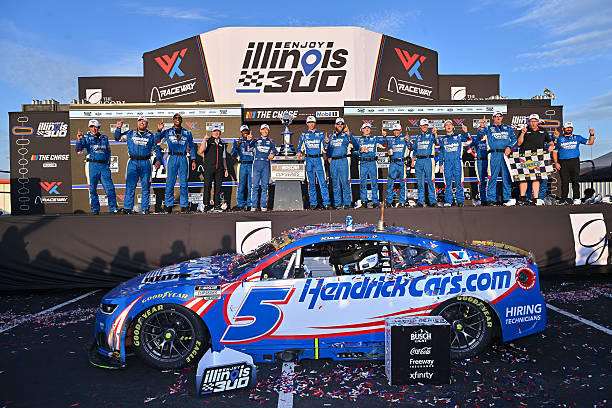 Kyle Larson, driver of the HendrickCars.com Chevrolet, and crew celebrate in victory lane after winning the NASCAR Cup Series Enjoy Illinois 300 at...