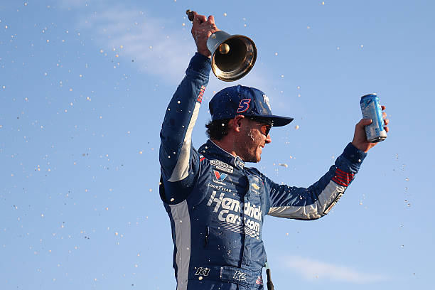 Kyle Larson, driver of the HendrickCars.com Chevrolet, celebrates in victory lane after winning the NASCAR Cup Series Enjoy Illinois 300 at WWT...
